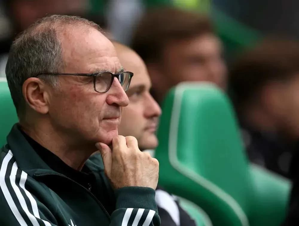 Coach sitting on bench during match