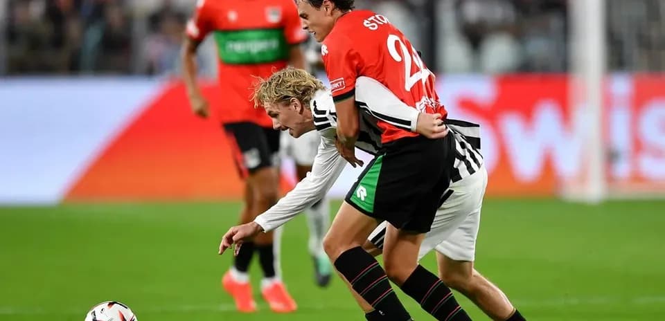Two players competing for the ball during match