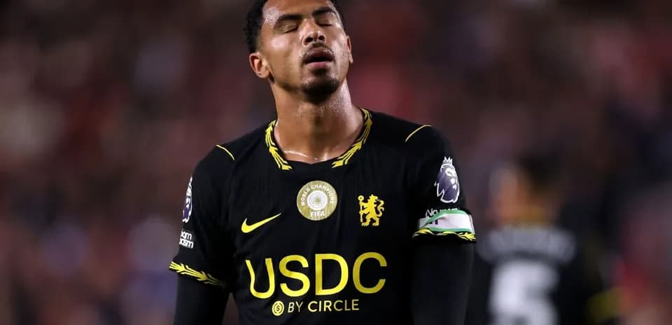 Player in black jersey looking down during match