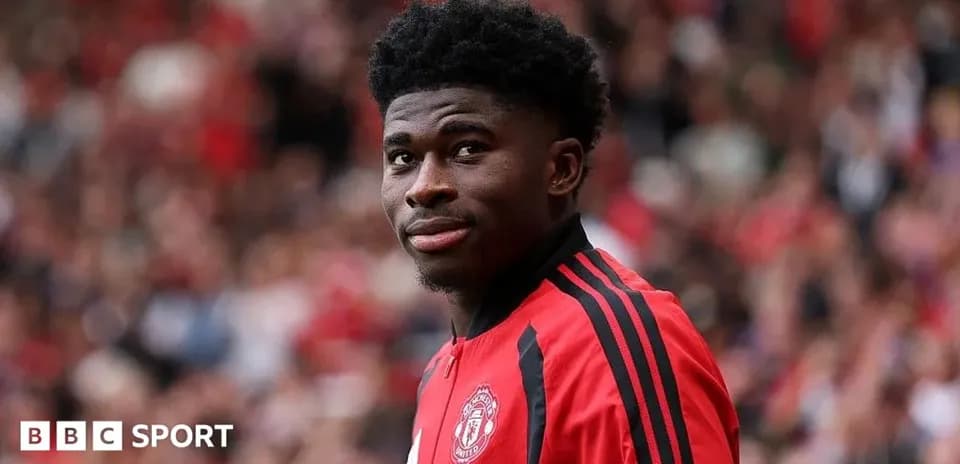 Player in red Manchester United kit at stadium