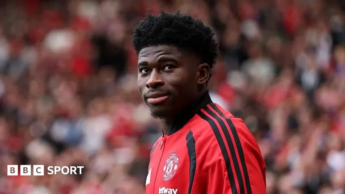 Player in red Manchester United kit at stadium