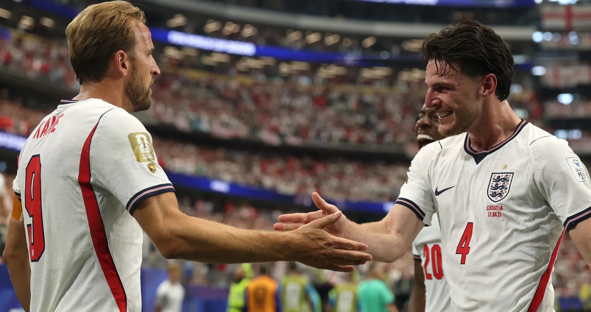 Harry Kane and teammate celebrating on the pitch