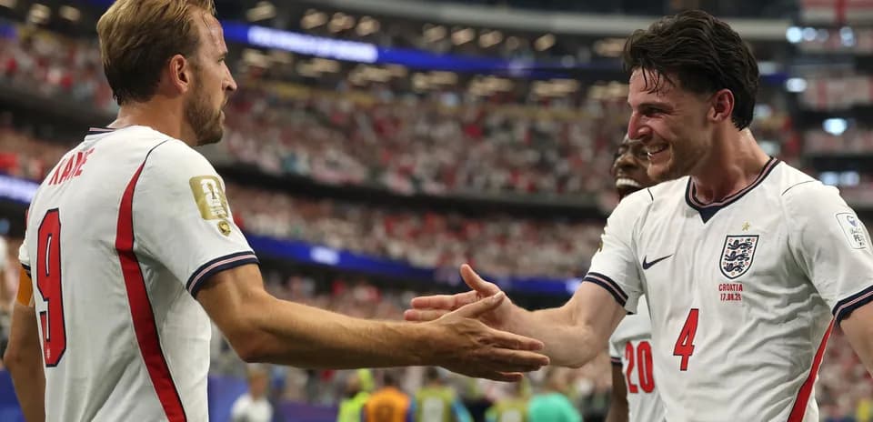 Harry Kane and teammate celebrating on the pitch