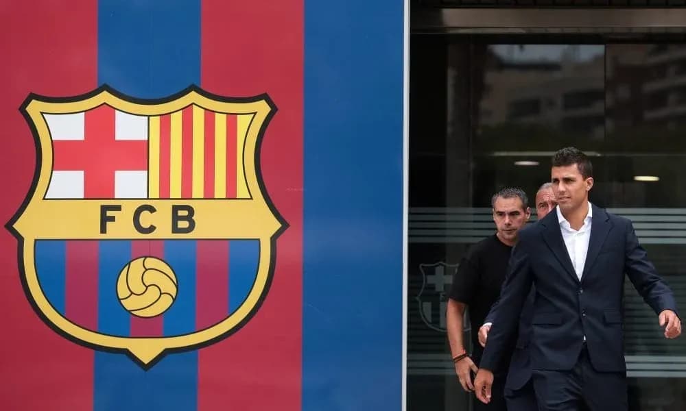 Player exiting building next to FC Barcelona logo