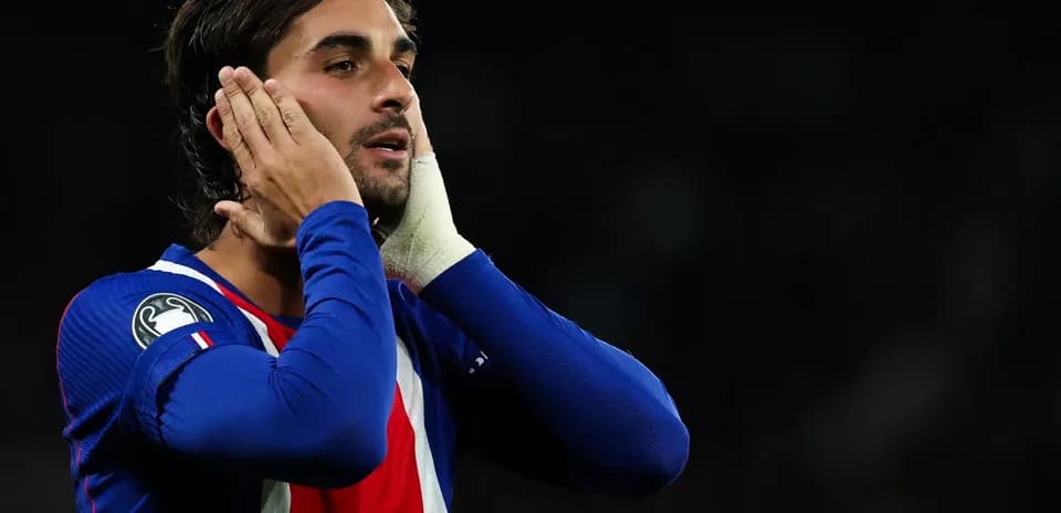 Player in blue jersey touching his face during match