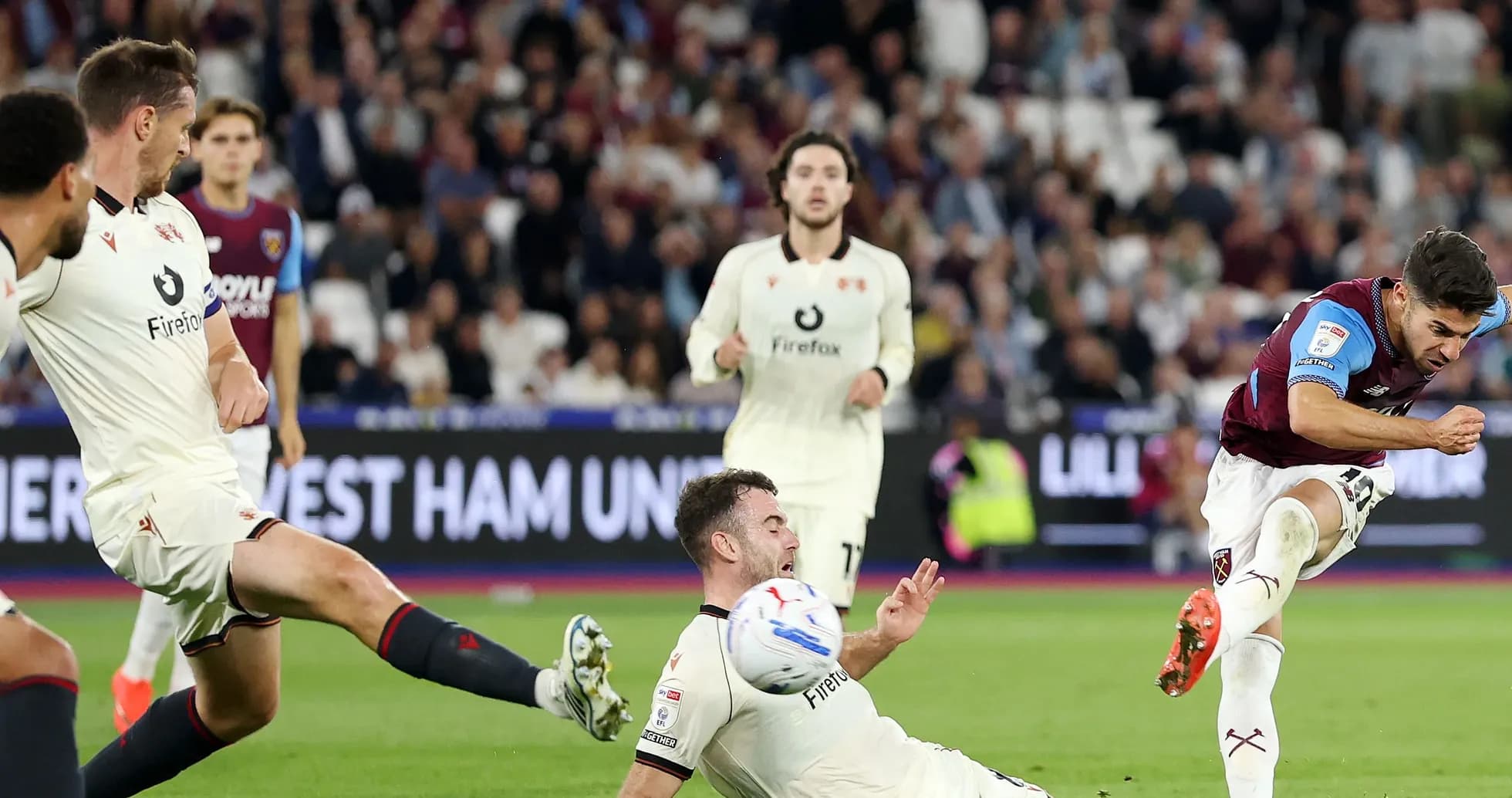 Player shooting the ball while opponent falls