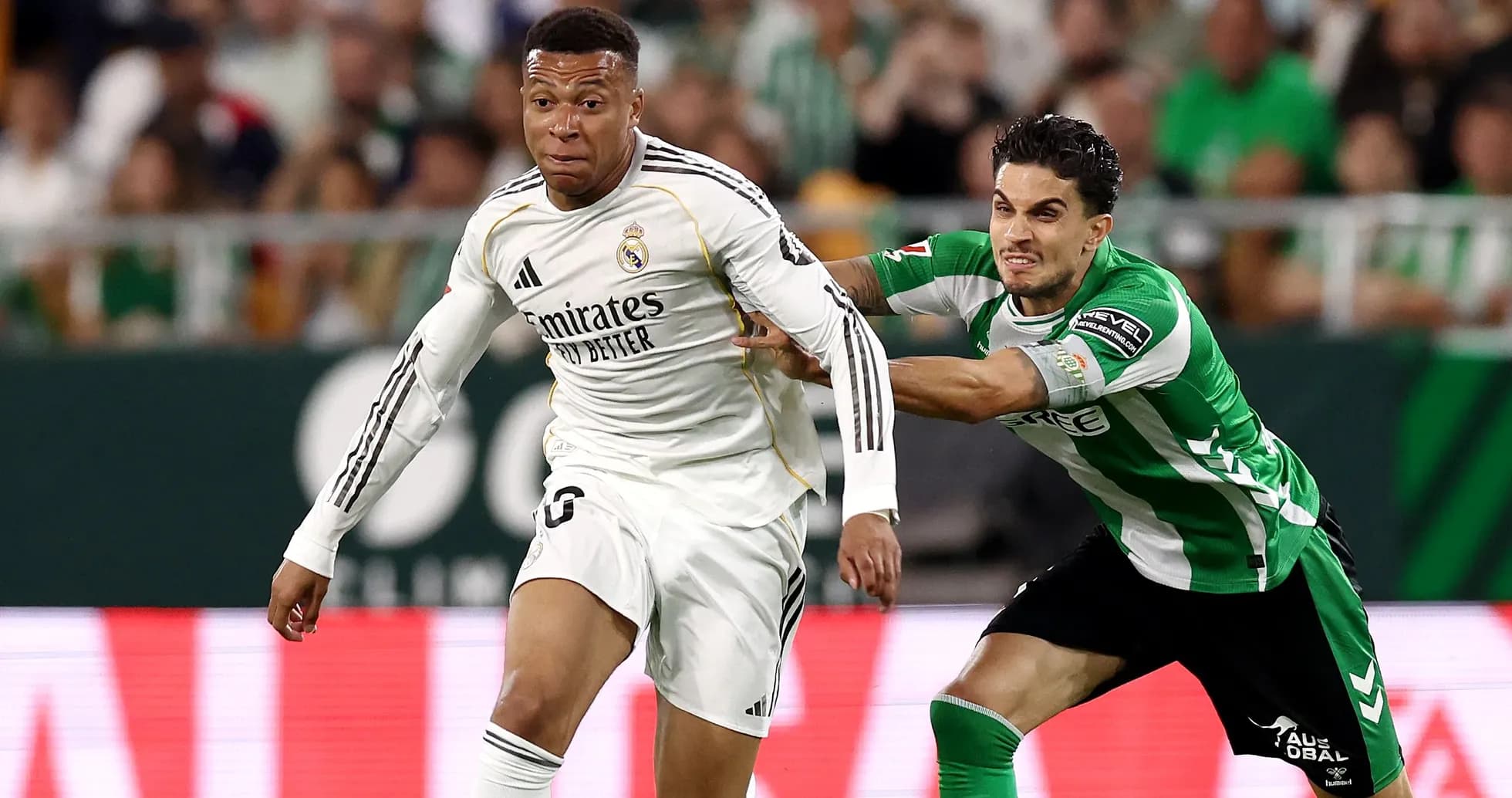 Player in white evading tackle from opponent in green