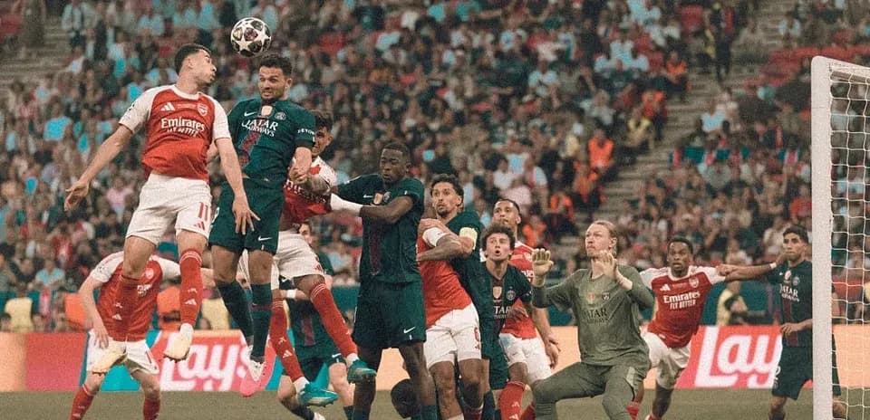 Players contesting a high ball in penalty area