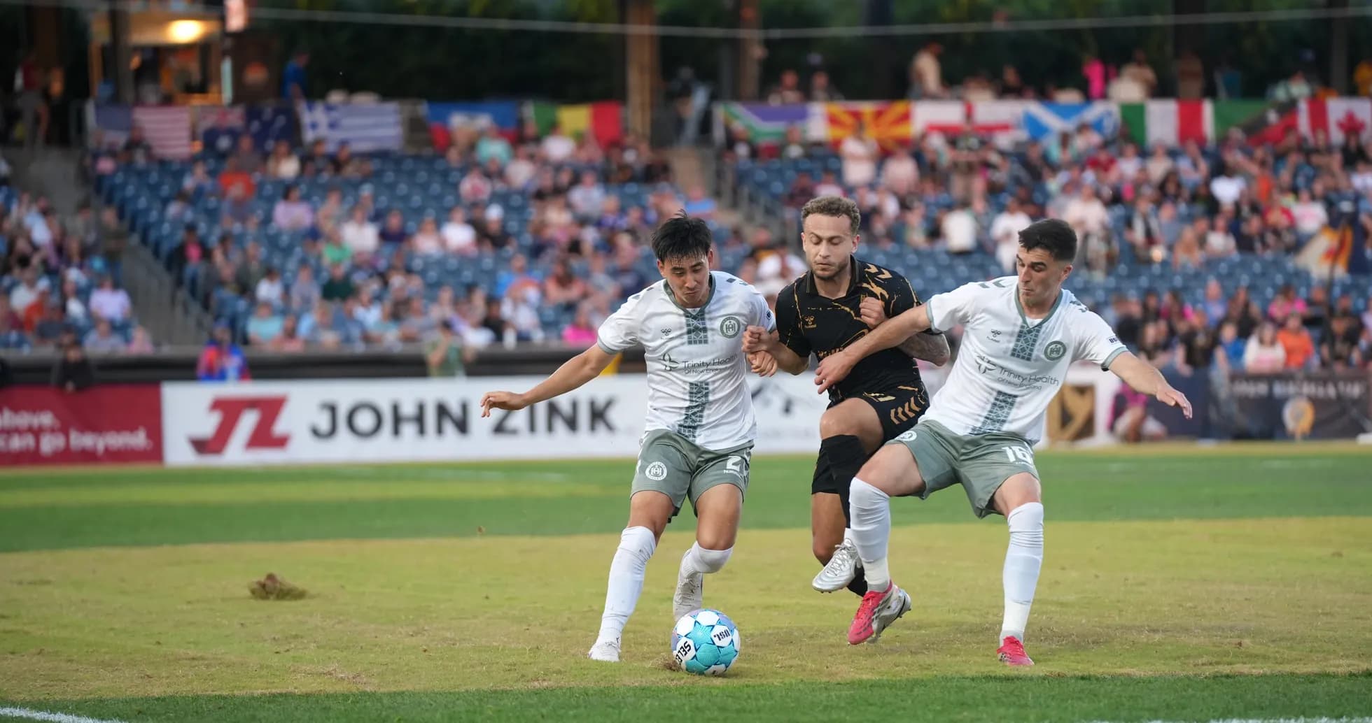 Two players competing for the ball in football match