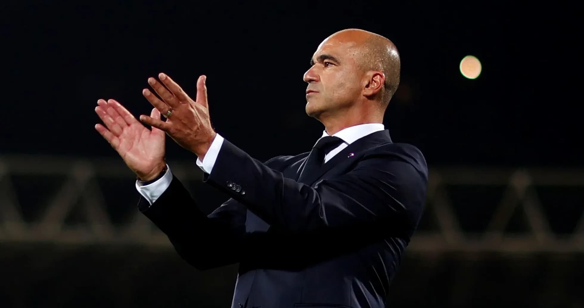 Manager applauding during a match on the sidelines