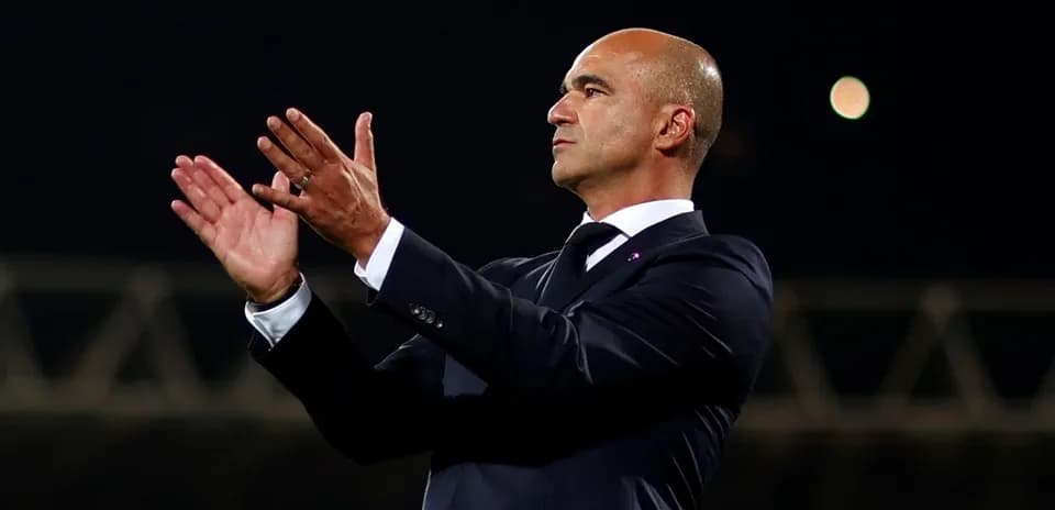 Manager applauding during a match on the sidelines