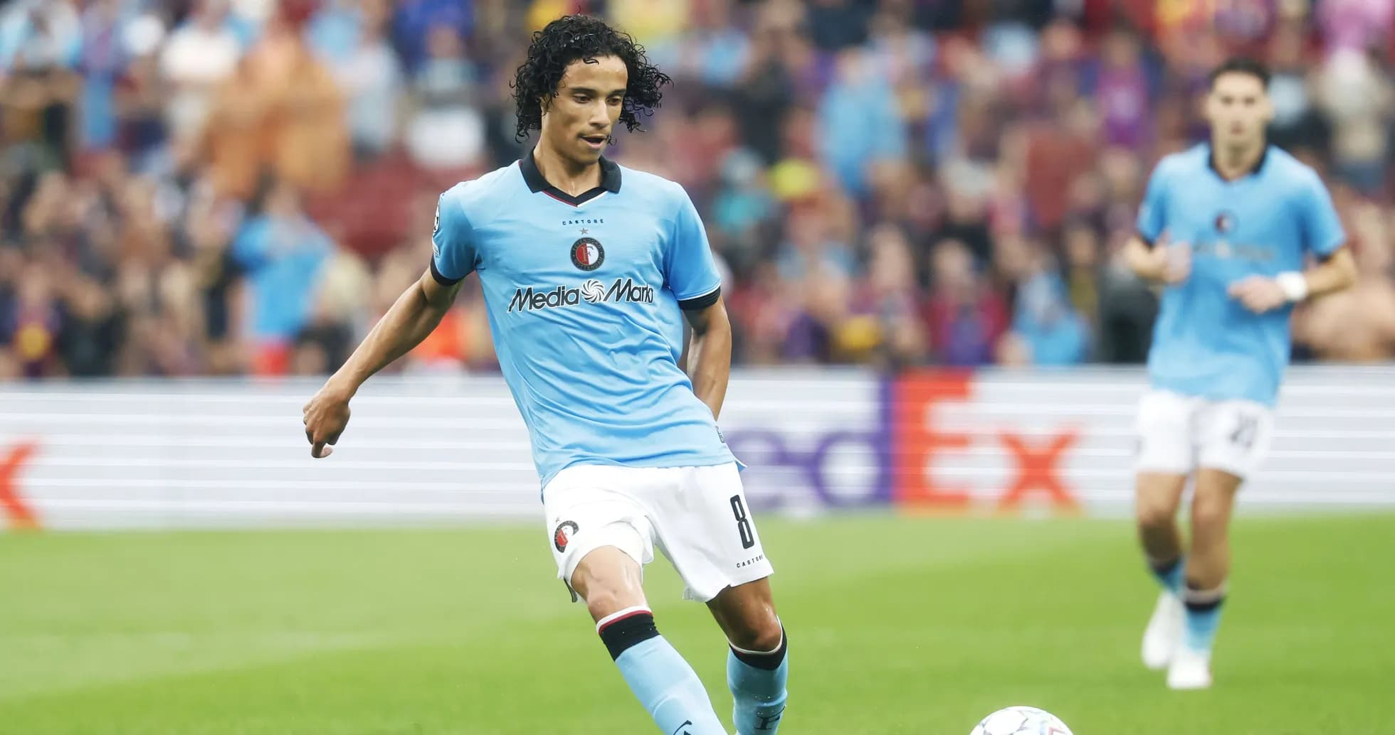 Player in blue kit passing the ball on field