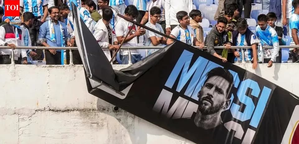 Fans with Argentina jerseys near Messi banner