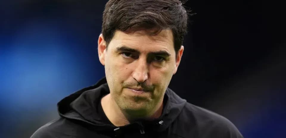 Coach wearing black jacket during match preparations