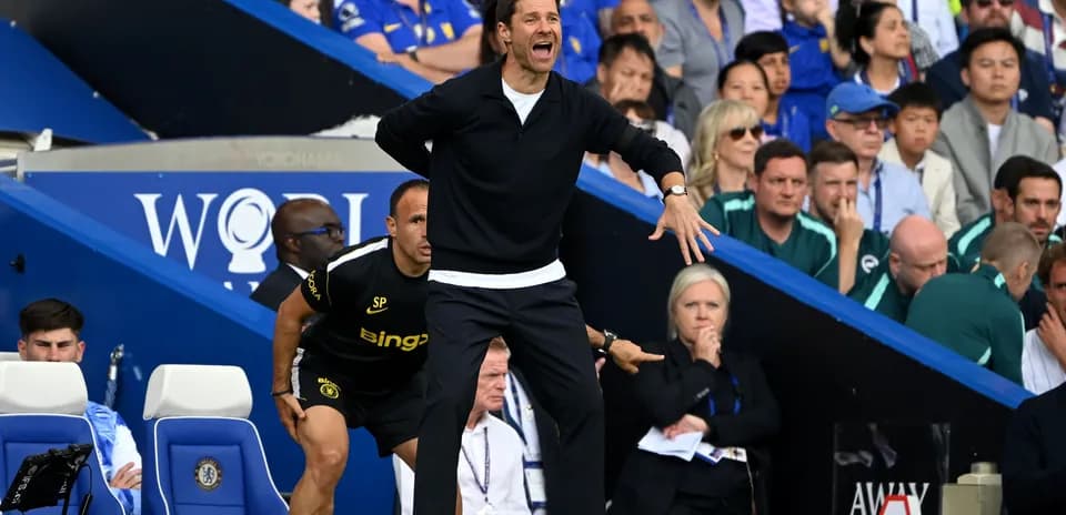 Coach gesturing from the sidelines during match