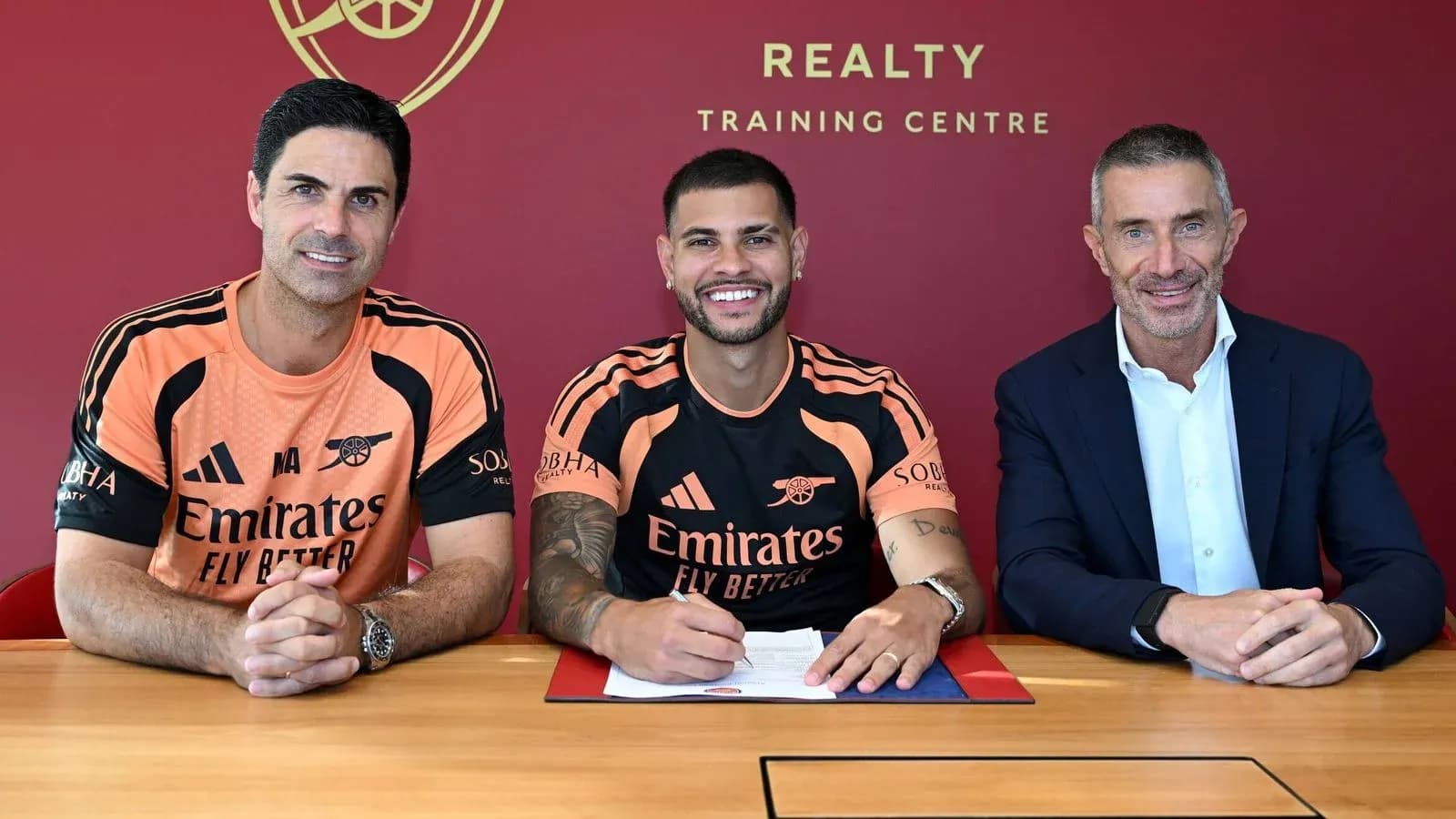 Player signing contract with club officials at training center