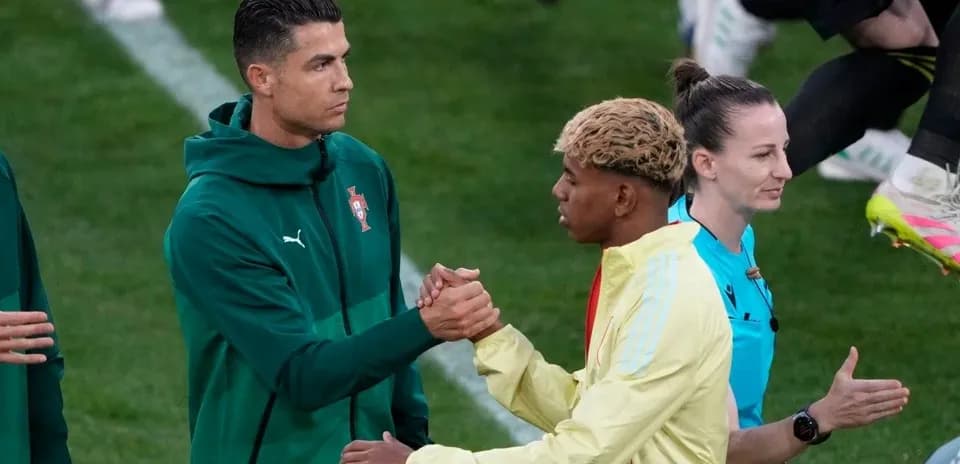 Players shaking hands before the match on field