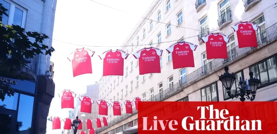 Red Arsenal jerseys hanging between buildings