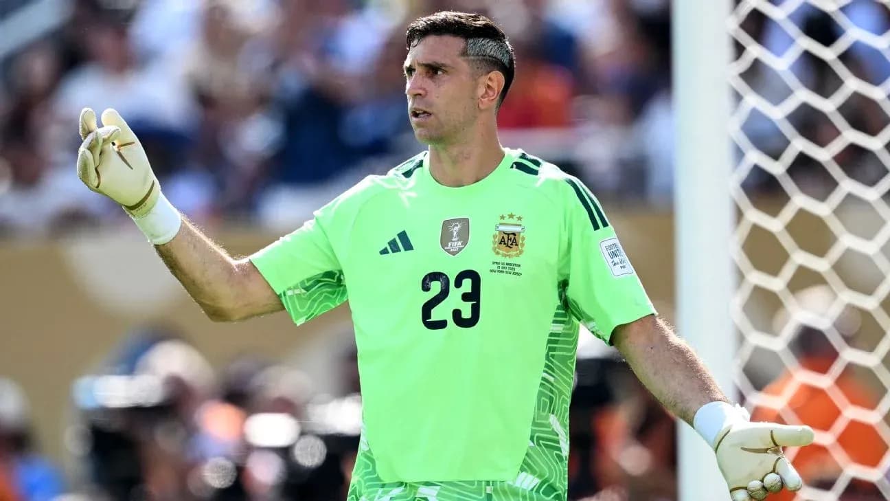 Goalkeeper in green jersey signaling during match