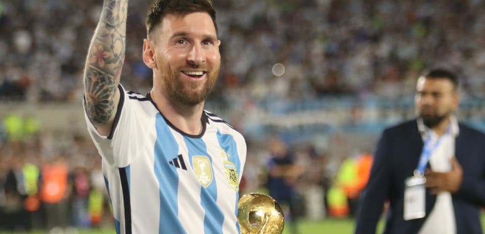 Player celebrating with World Cup trophy in hand