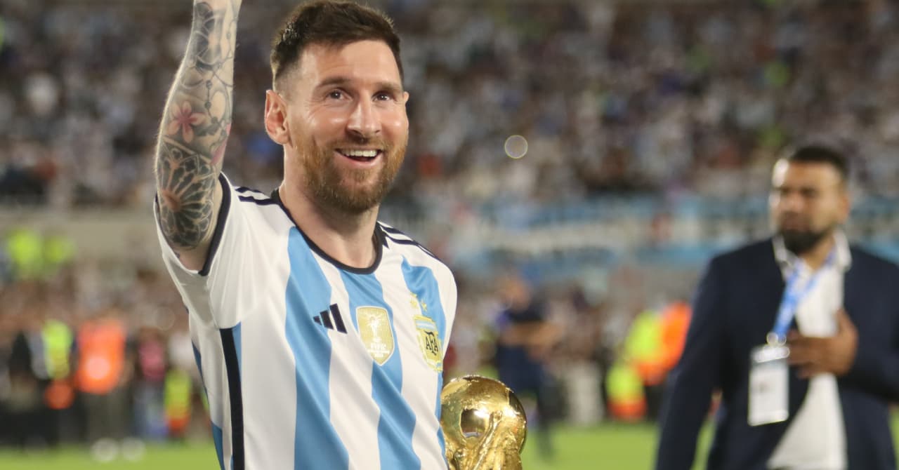 Player celebrating with World Cup trophy in hand