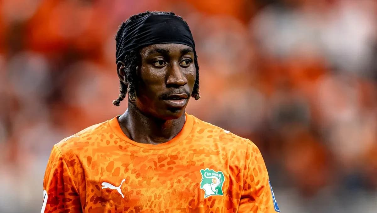 Player in orange jersey during match warm-up
