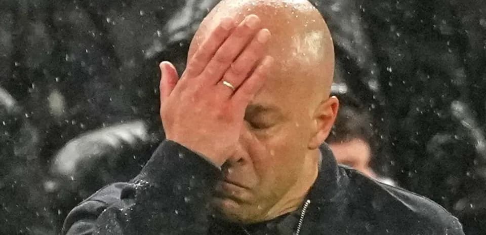 Coach covering face with hand during match