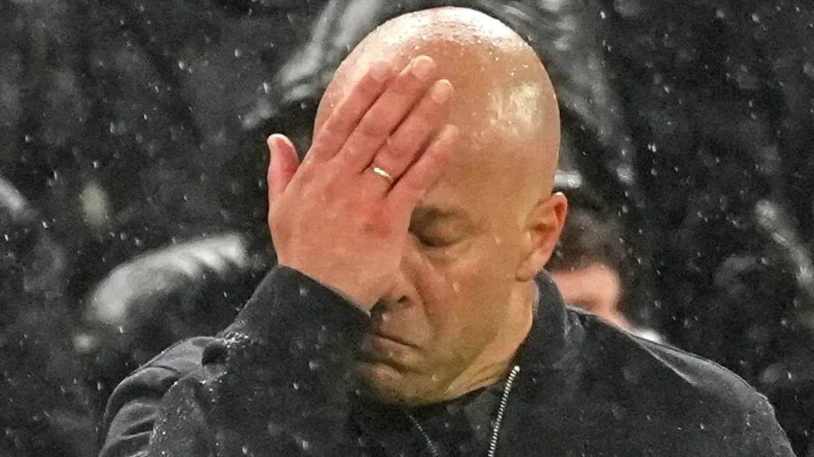 Coach covering face with hand during match