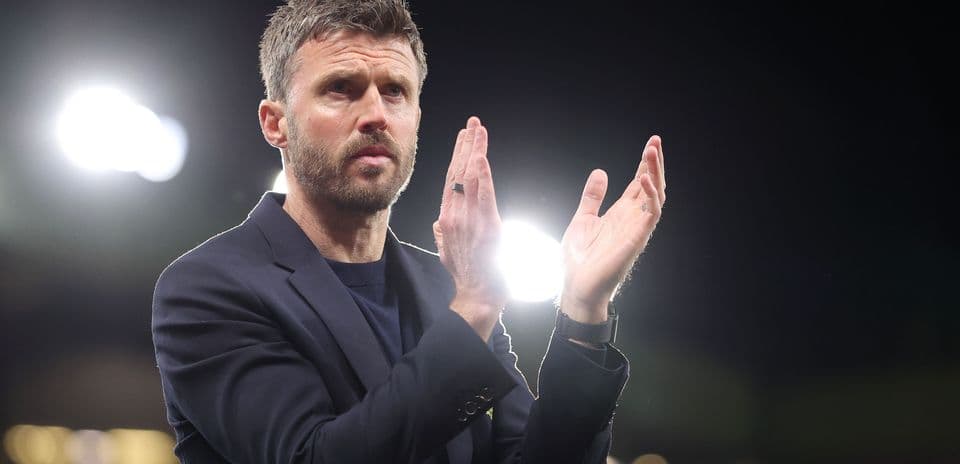 Manager applauding during a match at night