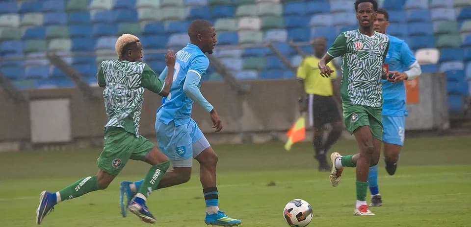 Players competing for the ball in CAF match