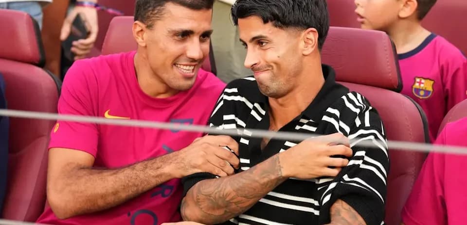 Two players sitting together in stadium seats