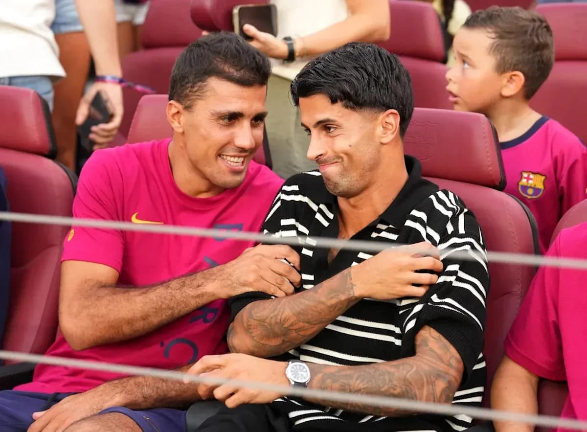 Two players sitting together in stadium seats