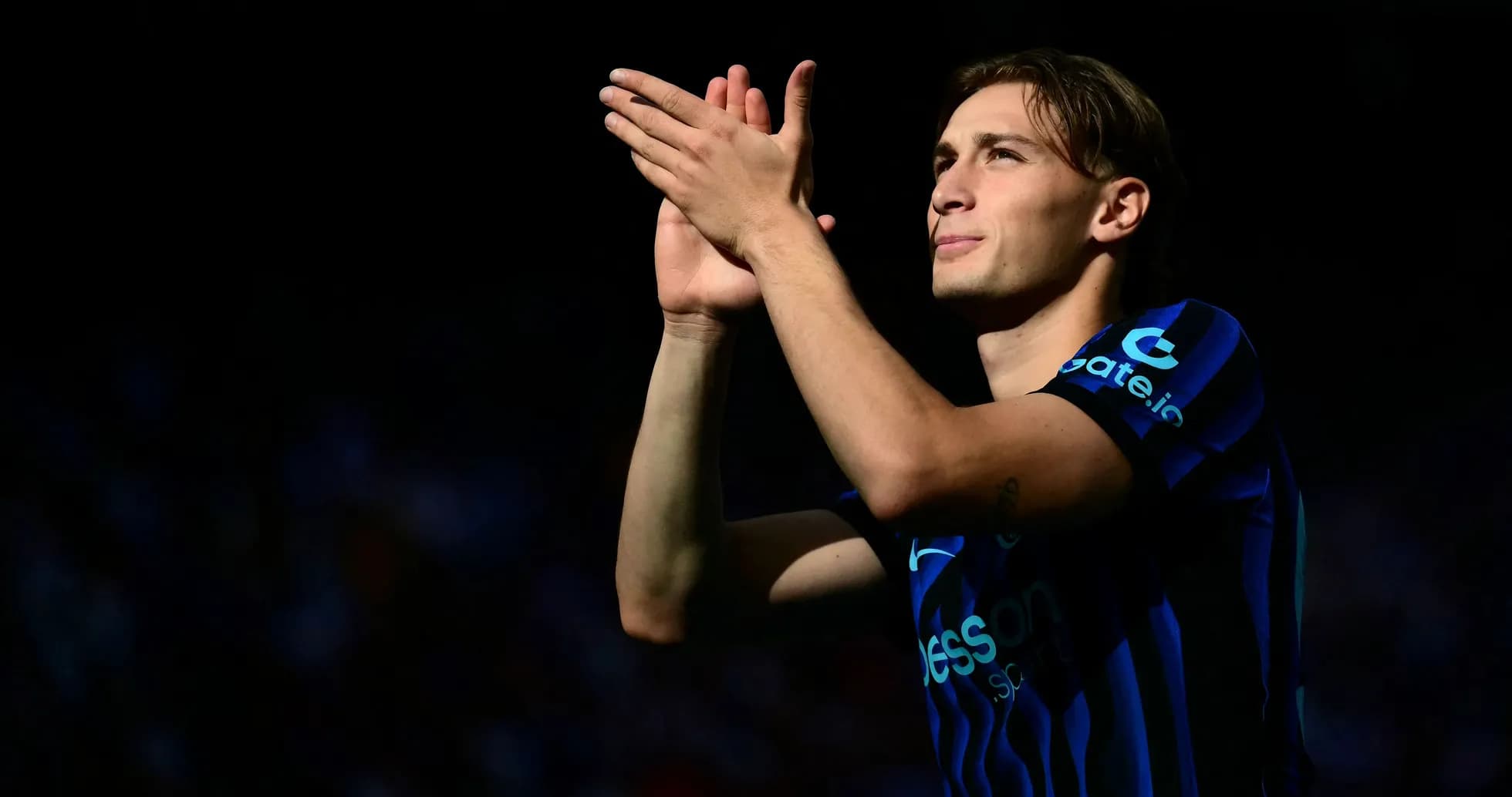 Player applauding fans during match at stadium