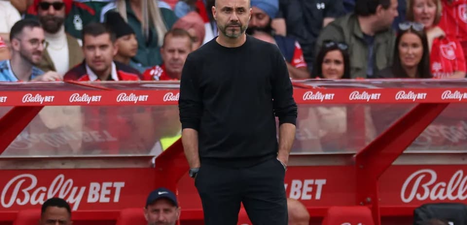 Manager standing on the sidelines during a match