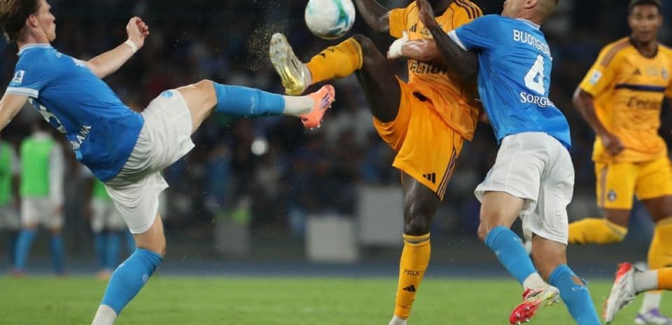 Pisa player tackles Napoli opponent during match