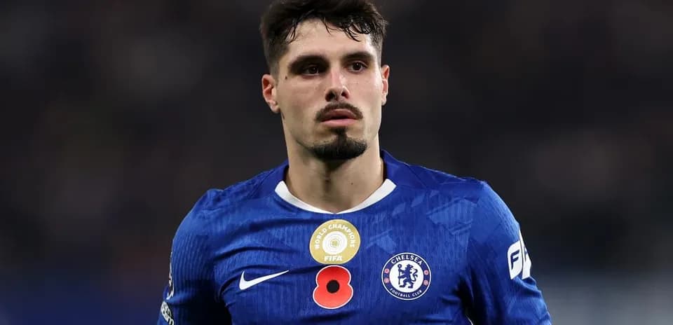 Player in blue Chelsea kit on the field