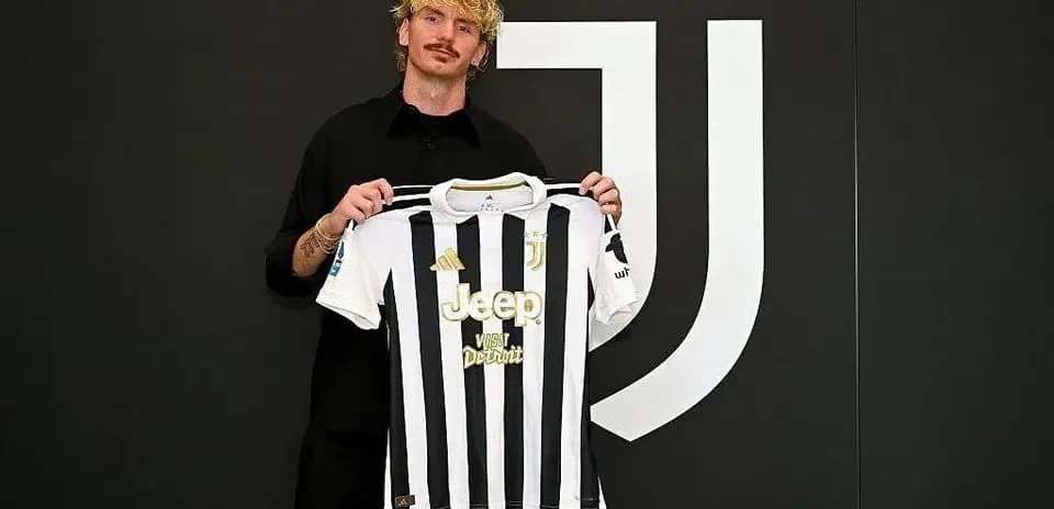 Player holding Juventus jersey during signing event
