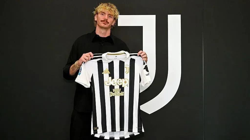 Player holding Juventus jersey during signing event