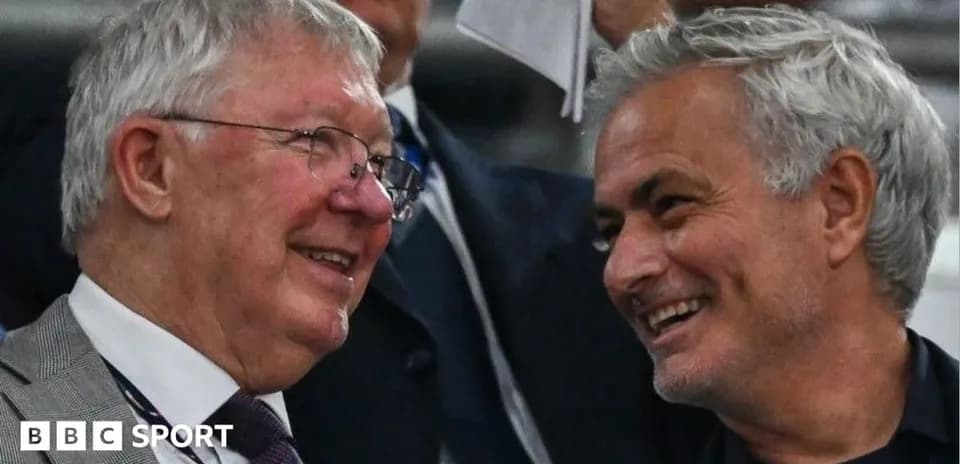 Two men smiling and conversing in the stands