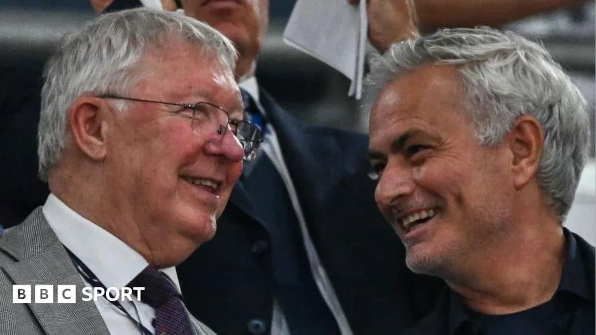 Two men smiling and conversing in the stands