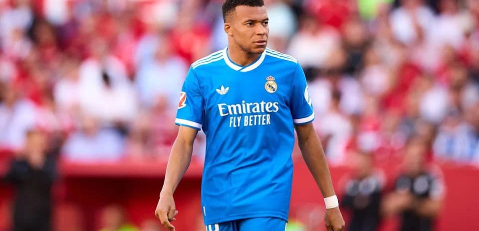 Player walking on the pitch in blue jersey