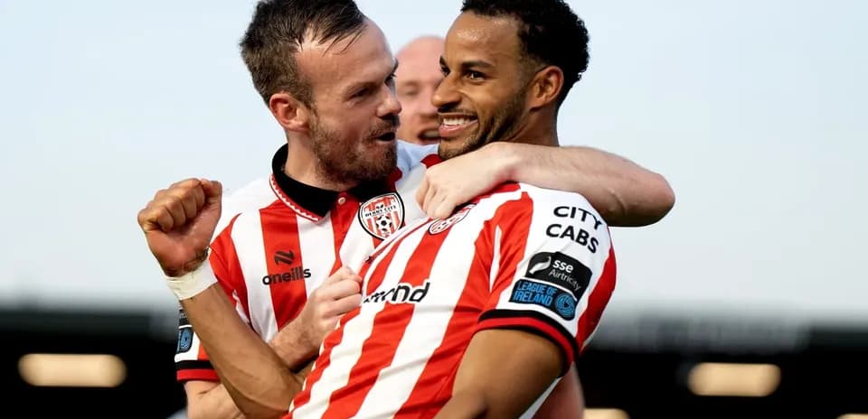 Two players celebrating a goal for Derry City