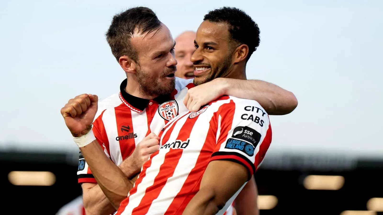 Two players celebrating a goal for Derry City