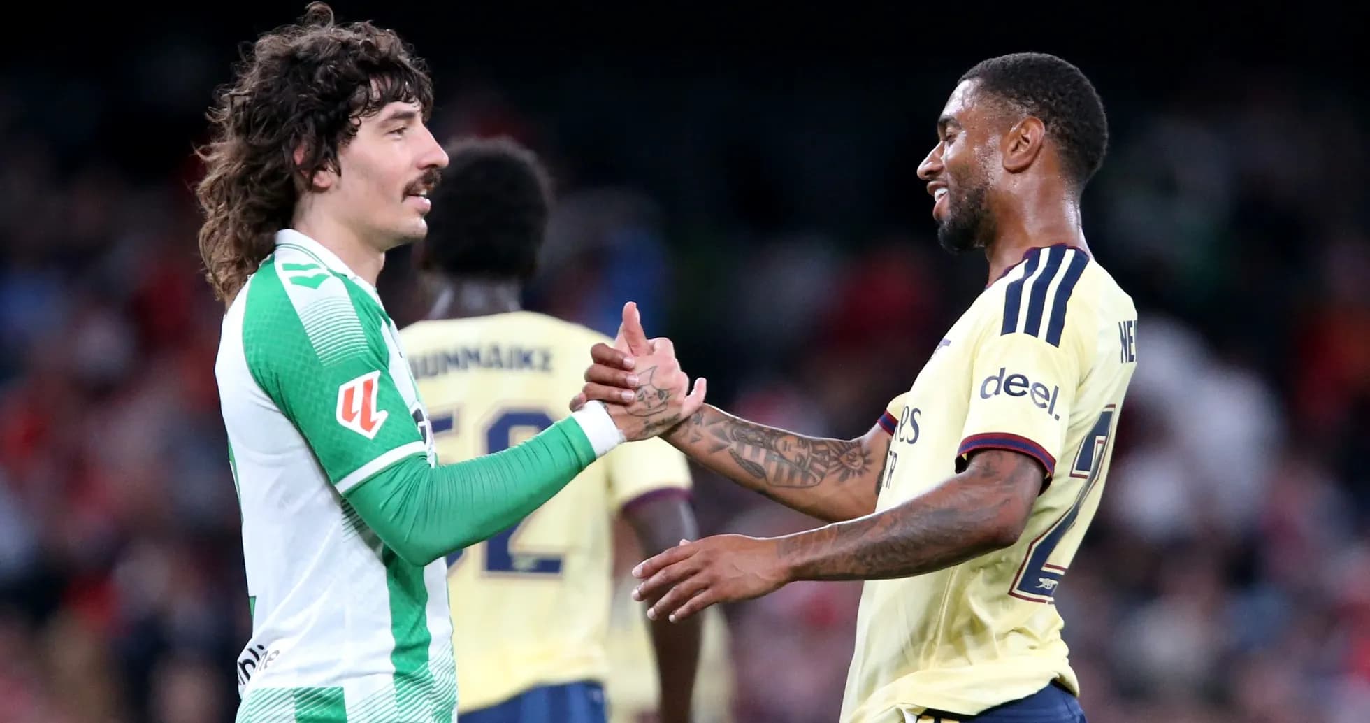 Two football players shaking hands after match