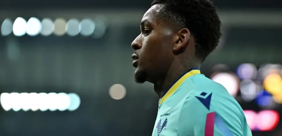 Player in teal jersey during match warm-up