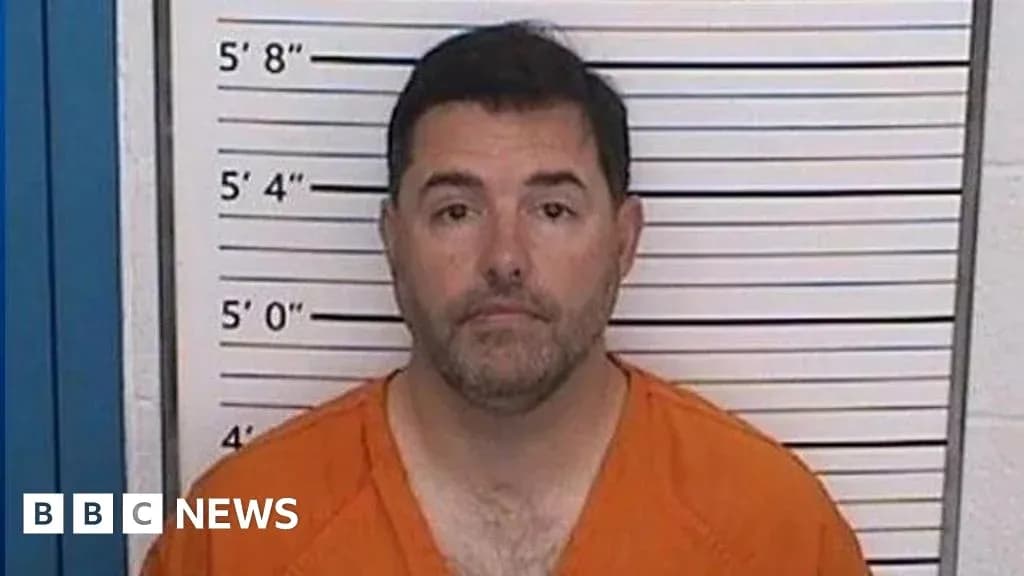 Man in orange jumpsuit at height chart backdrop