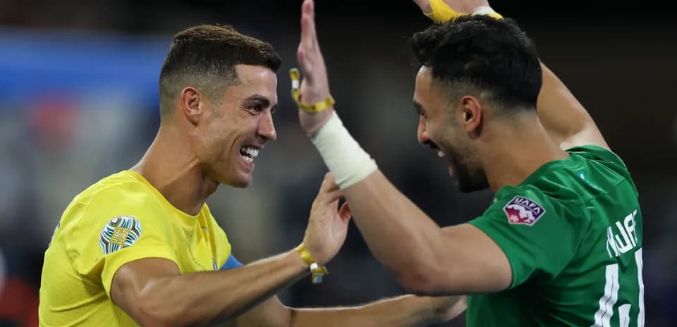 Two players celebrating together on the field
