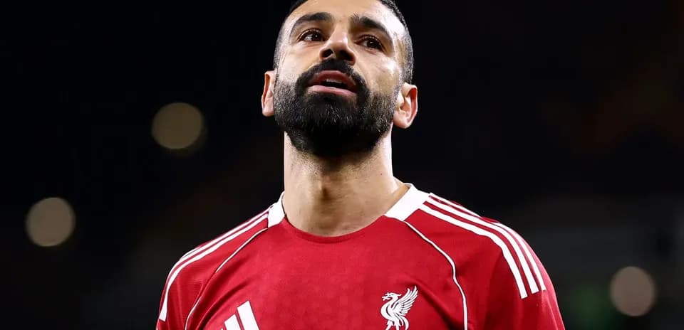 Player in Liverpool jersey looking upwards