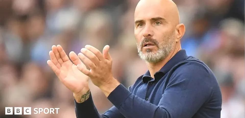 Coach applauding during a match from the sidelines