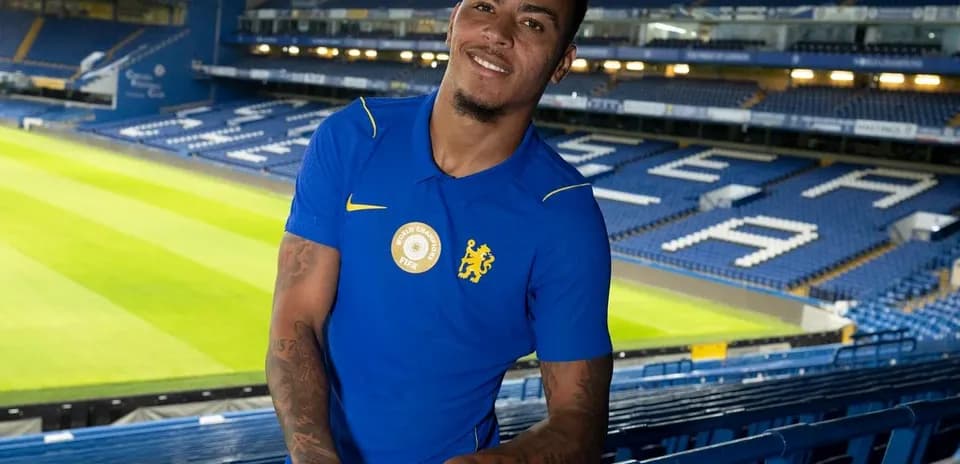 Player posing in stadium with Chelsea colors